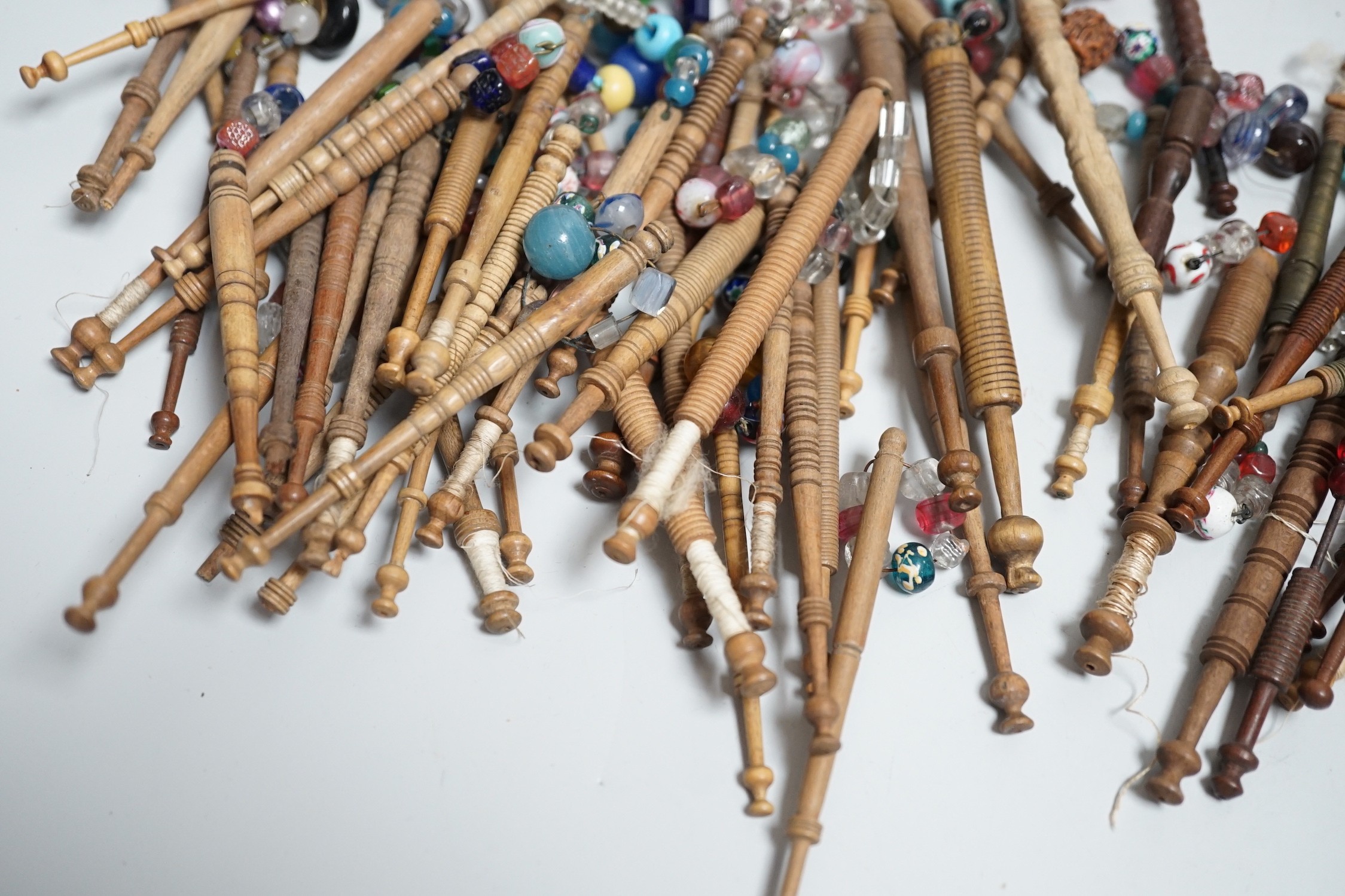 Fifty 19th century finely turned wooden lace bobbins with beaded ends together with 35 ornate wooden bobbins with beaded ends and 5 plain wooden bobbins unleaded (90)